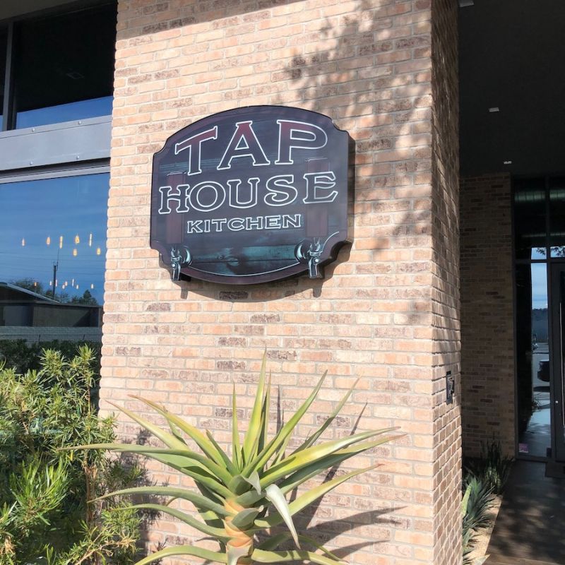Tap House Name Signage on a Brick Wall