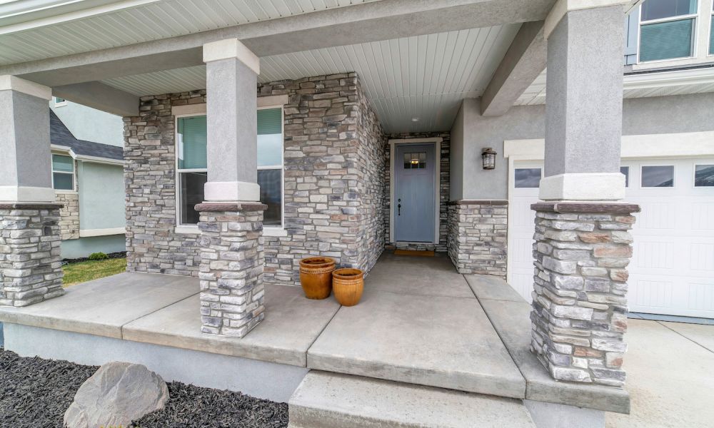 House exterior with stone veneer siding and garage
