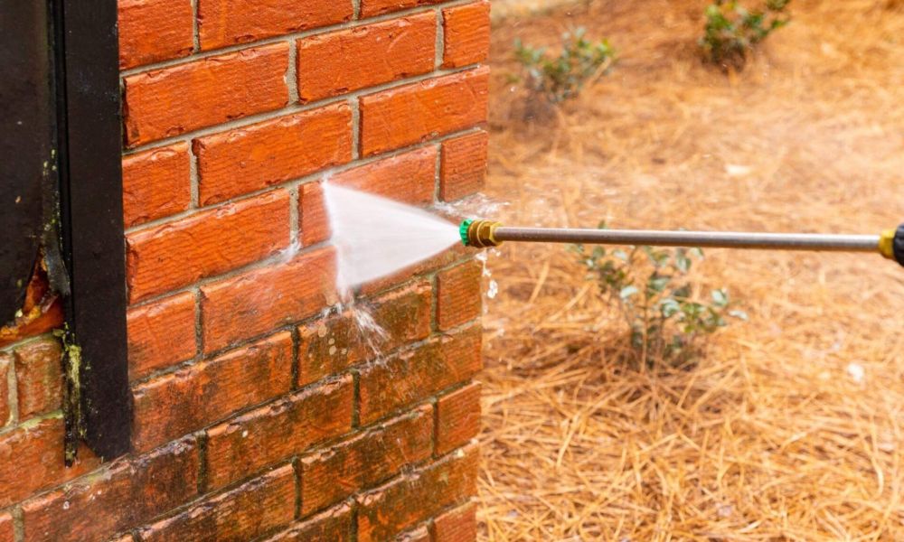 a fire hydrant spraying water on a brick wall