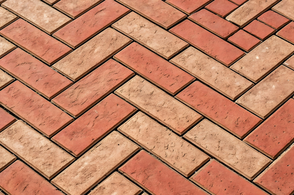 Red and brown herringbone brick pattern, ideal for durable paving and stylish outdoor flooring designs.