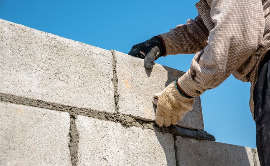 Man using mortar and cement blocks