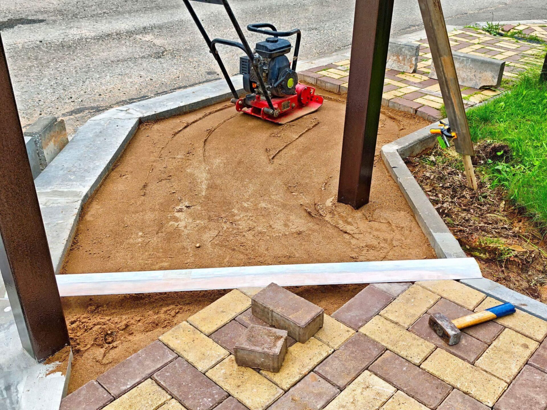 a construction site with bricks and a machine to compact the floor