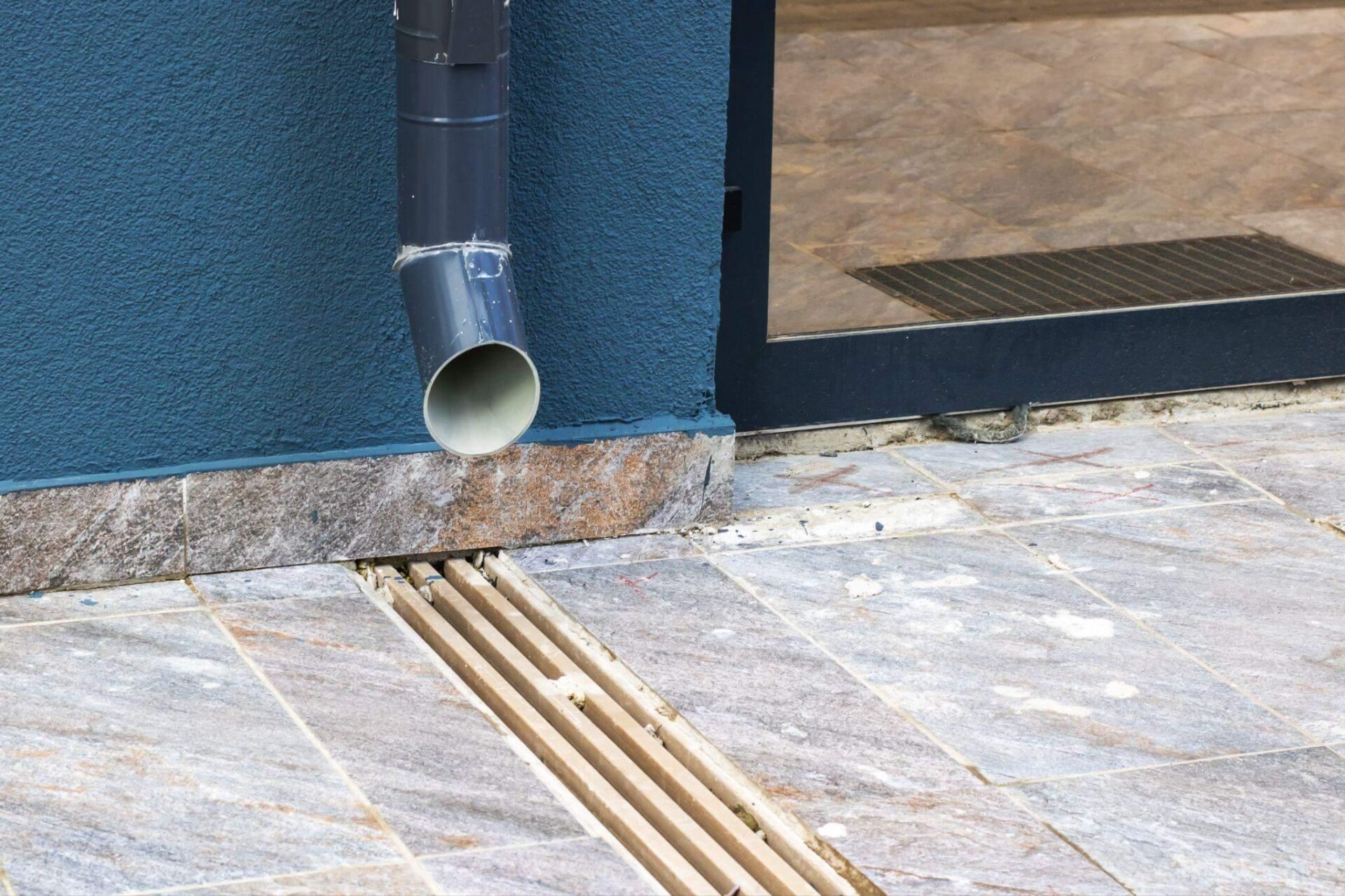 a pipe sticking out of the side of a building to a flood vent in the floor