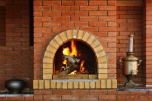 A roaring fire glowing within a brick fireplace