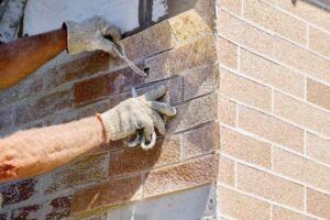 Worker building a brick wall